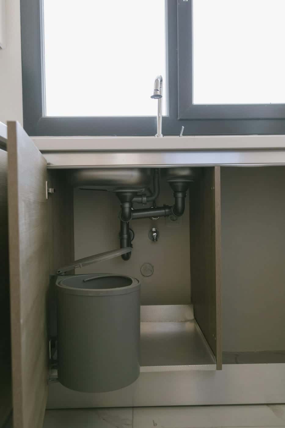 Residential plumbing under a kitchen sink