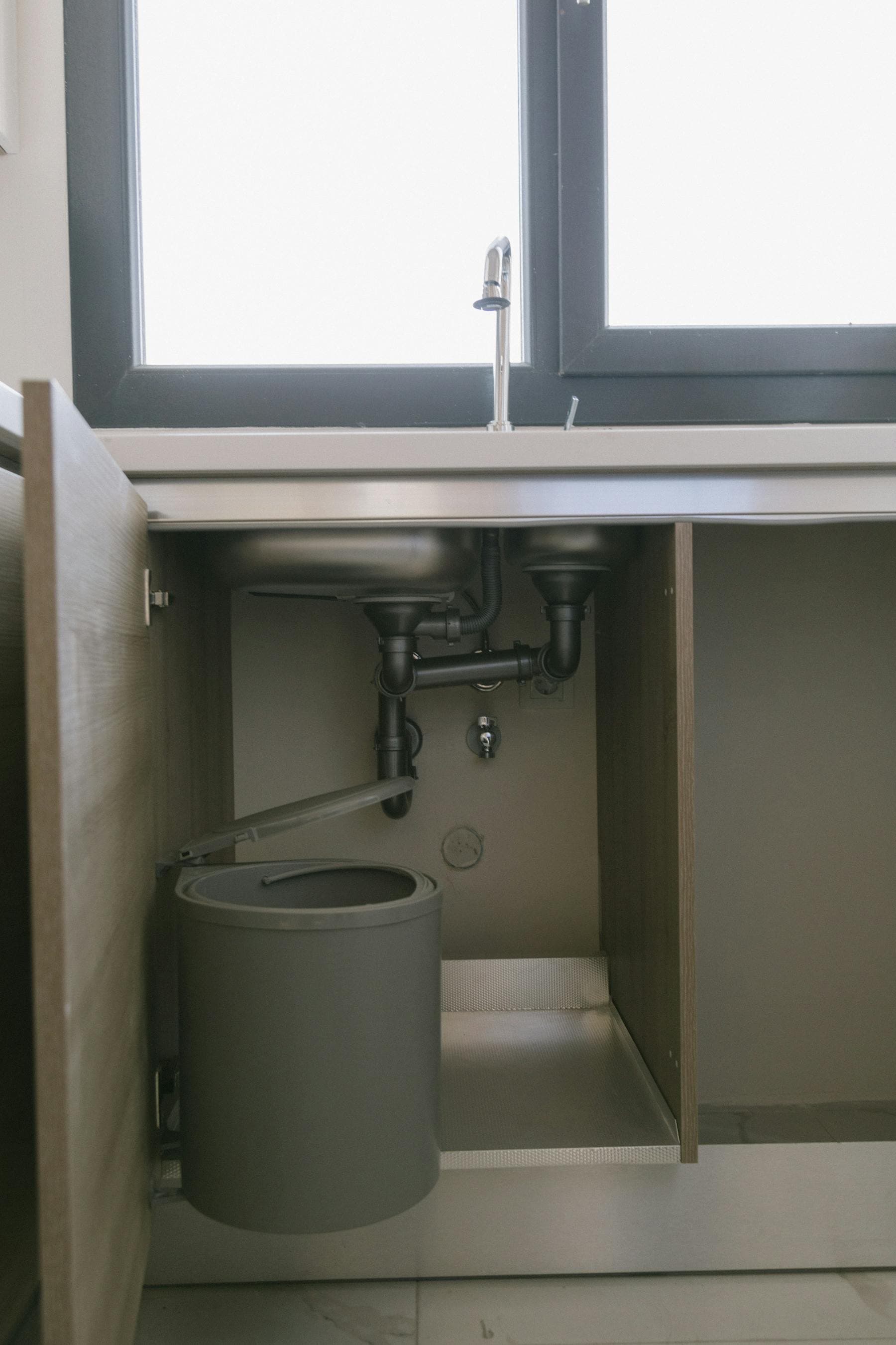 Residential plumbing under a kitchen sink