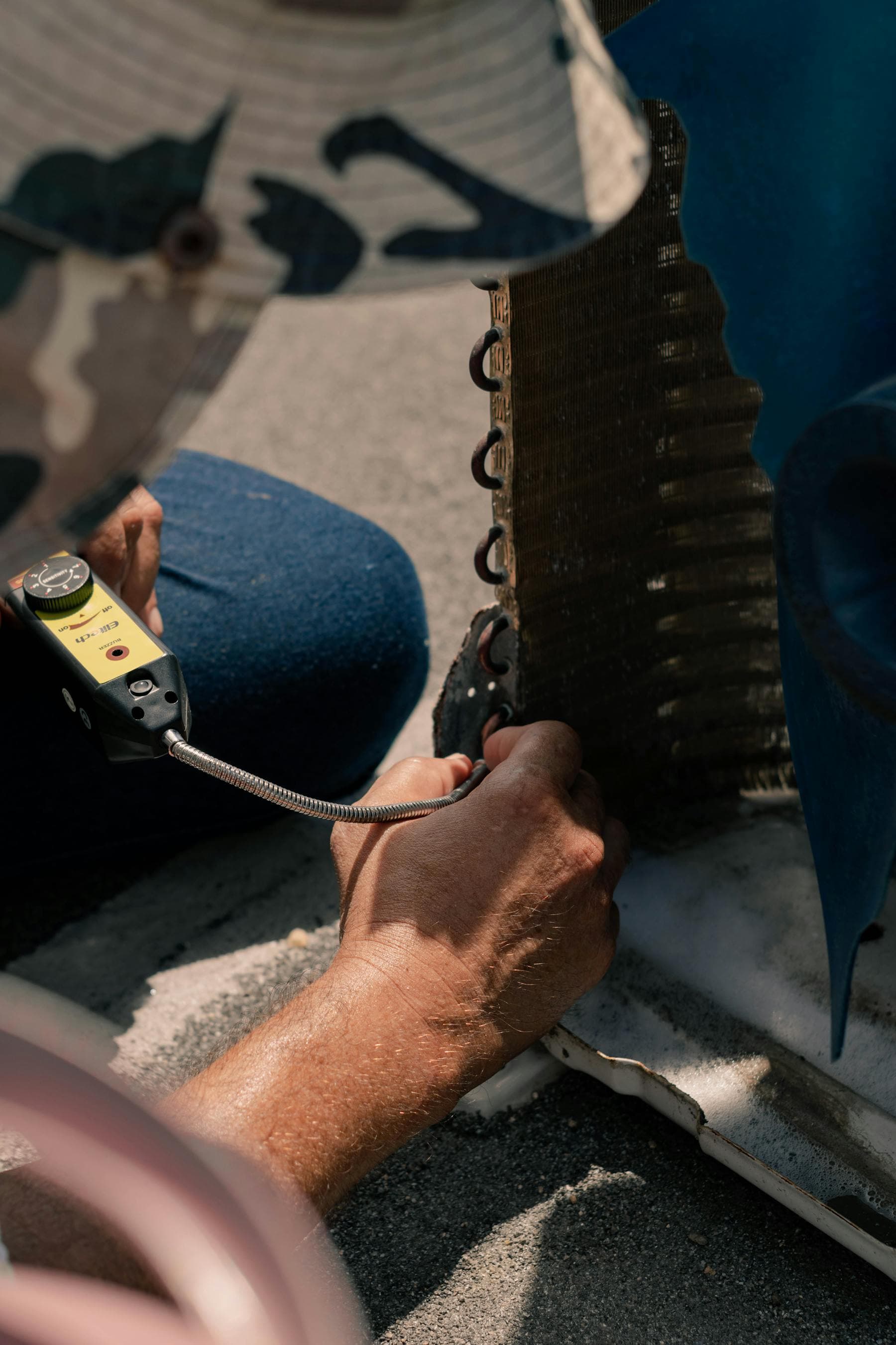 Technician servicing air conditioning equipment